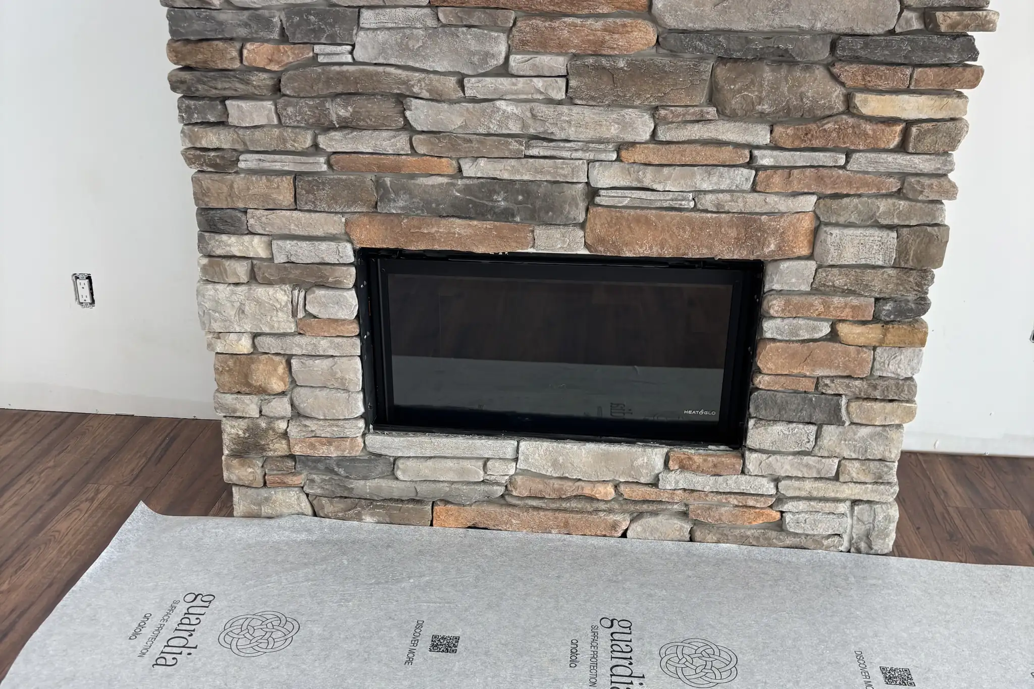 Finished stone fireplace installed and hooked up by Hughes and Sons Gas