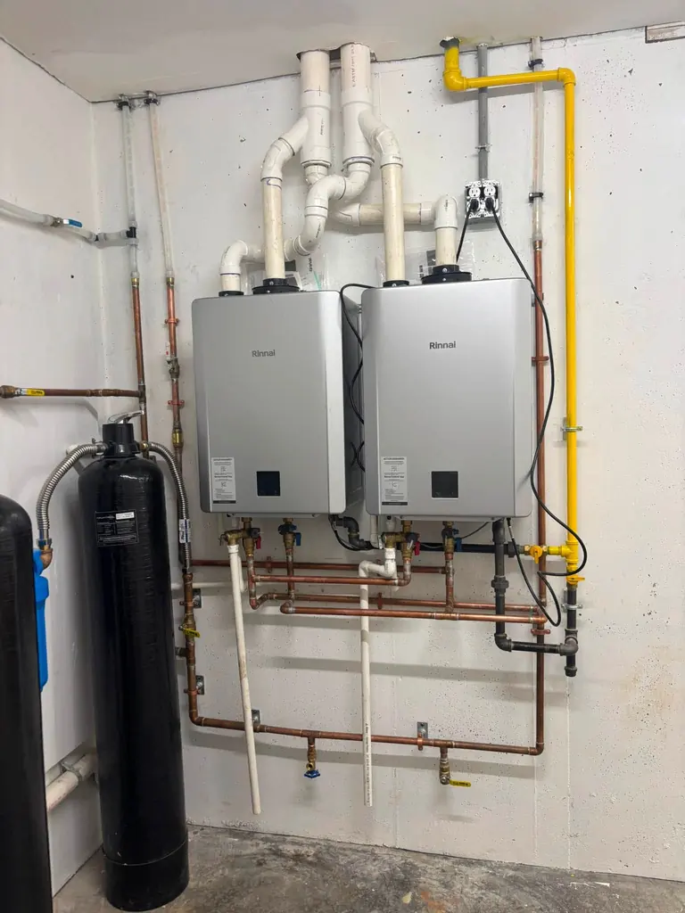 Two tankless water heaters and their gas line installed by Hughes and Sons Gas