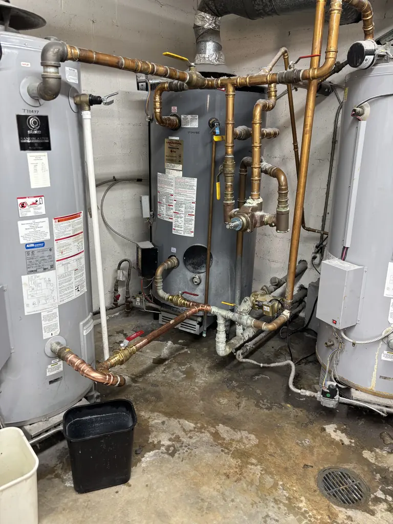 Bank of commercial water heaters with copper and gas piping