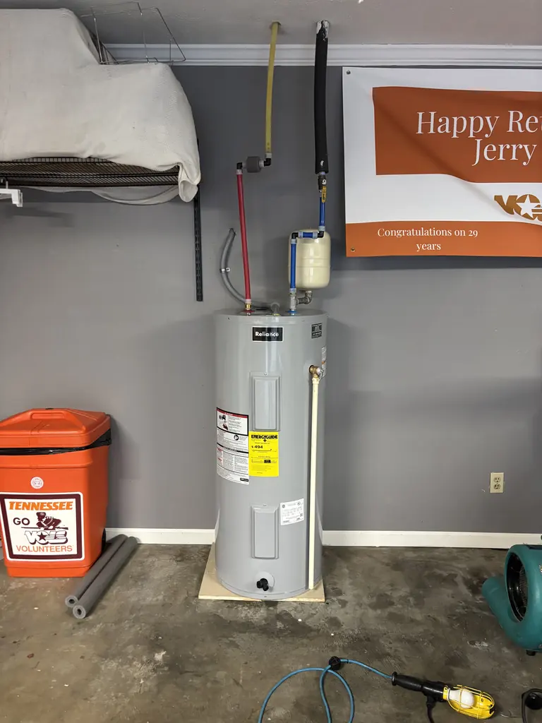 Electric tank water heater installed in a garage