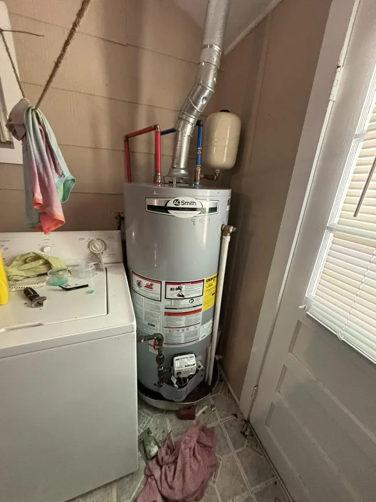 Gas water heater installed in a laundry room