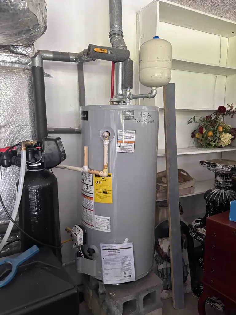 Tank water heater installed with an expansion tank